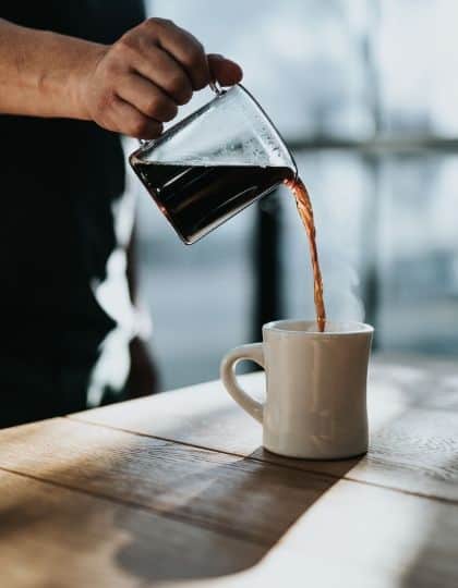 pouring brewed coffee in cup