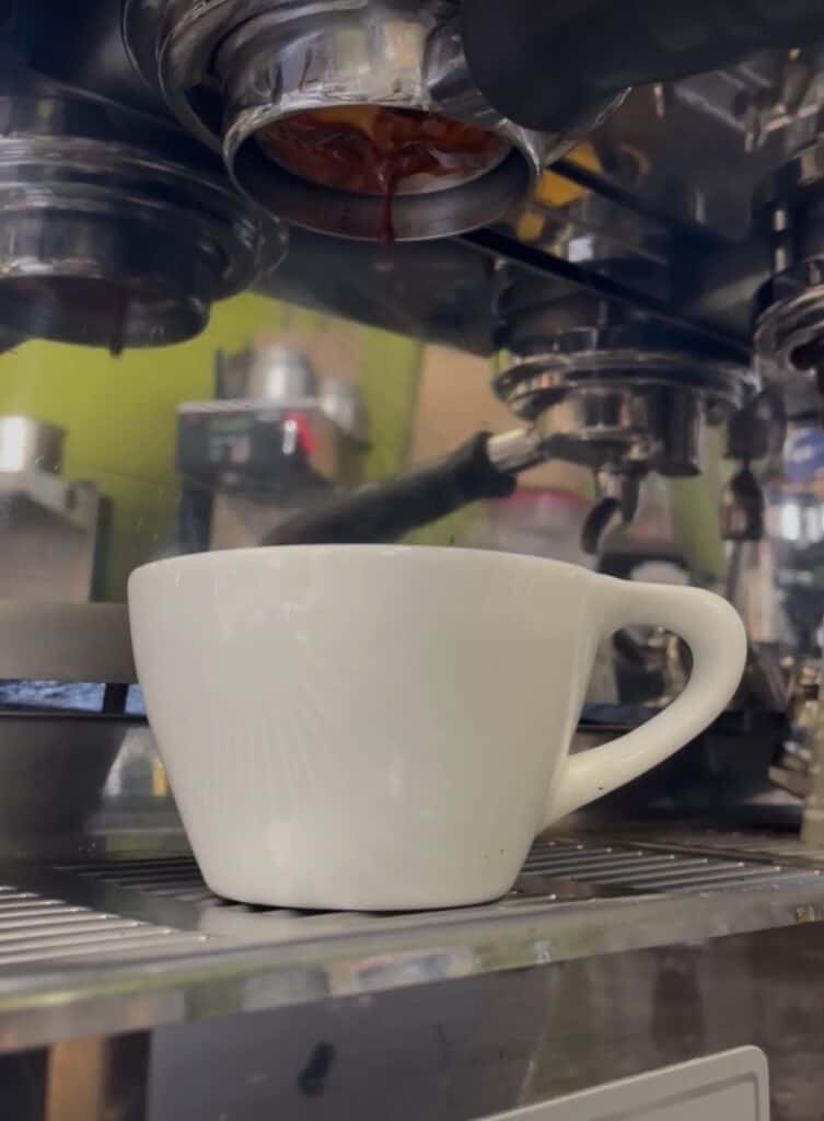 Image of over extracted espresso pulling from machine. Dripping slowely.